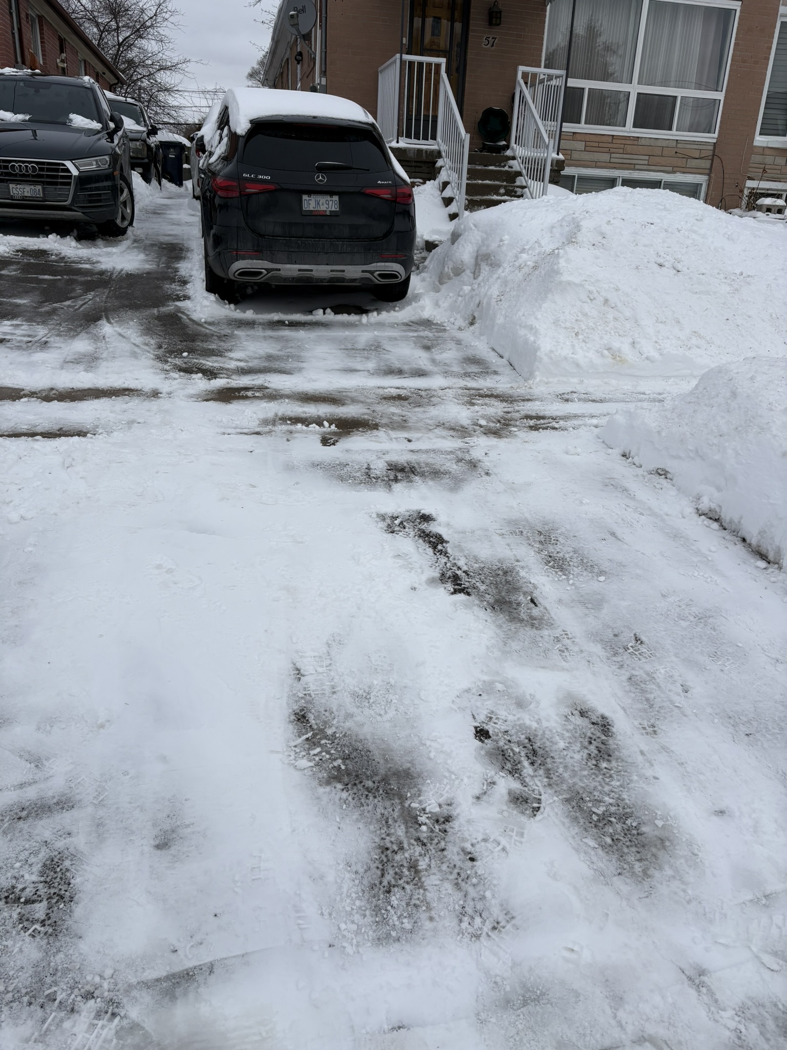 Driveway cleared between parked cars
